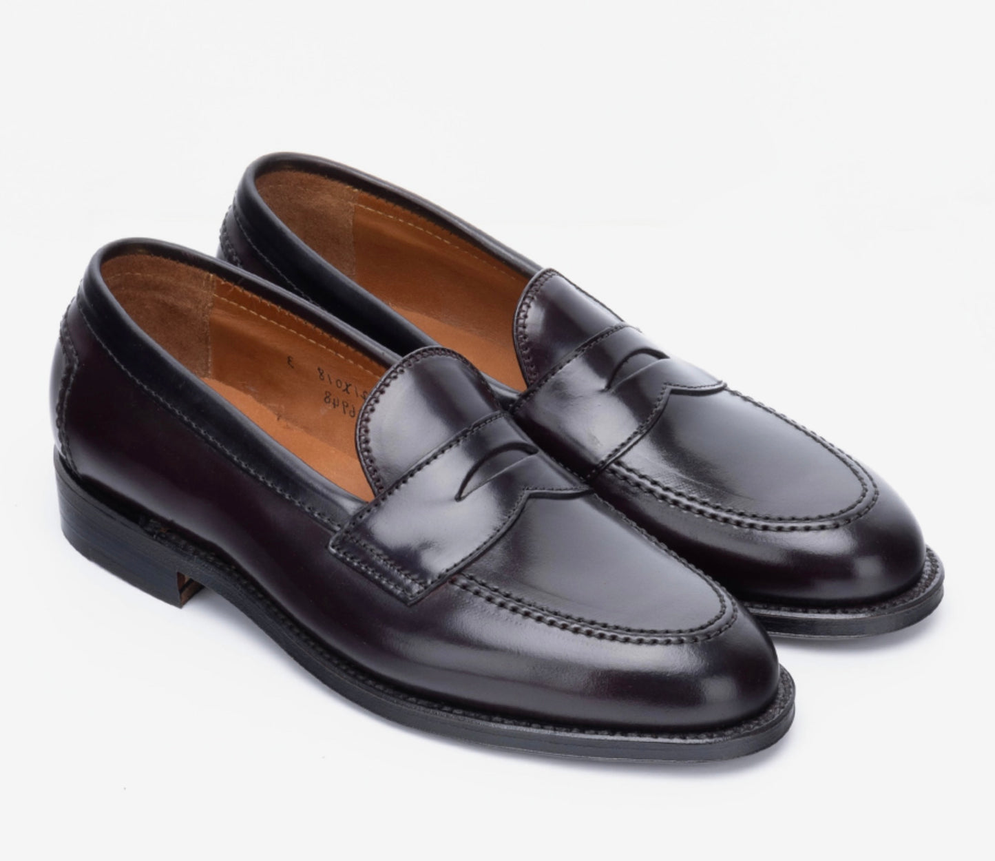 The ALDEN SHOES 96948 - Copley Penny Color 8 Shell (Flex Penny Style) features polished dark brown leather, stitching details, low heels, a single leather sole, and tan leather interiors, showcased on a white background.