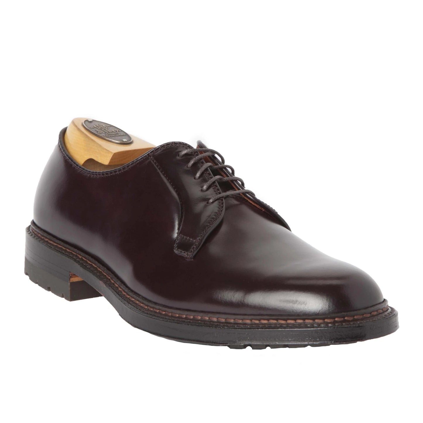 The Alden Madison 990C - Plain Toe Blucher features Color 8 Shell Cordovan leather, black laces, a commando sole with visible stitching, and a slight heel. Its crafted on the Barrie Last for exceptional style and comfort. A wooden shoe tree is included.