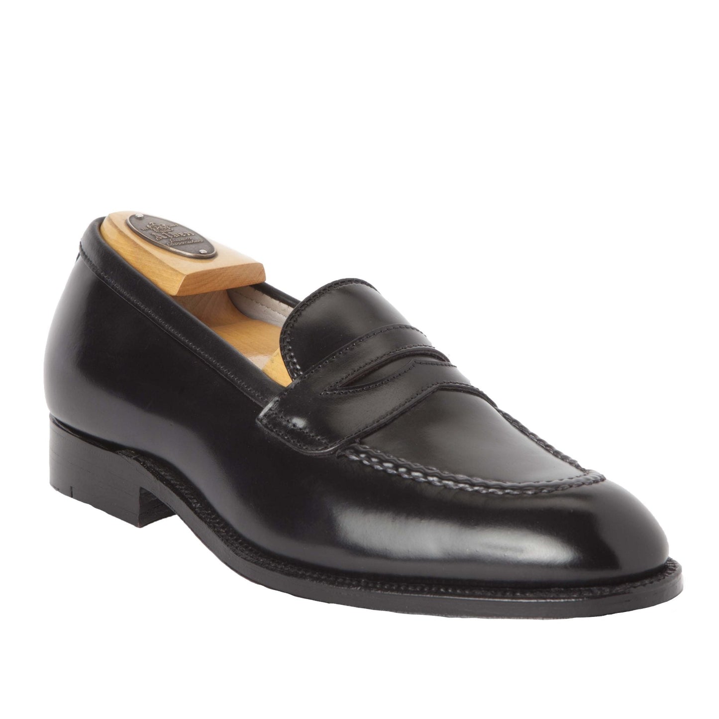 The Alden Madison 67269 High Vamp Loafer in Black Shell Cordovan features a penny slot, toe stitching, and is crafted on the Grant Last with a single oak leather sole. Shown with a wooden shoe tree inside. Deposit required.