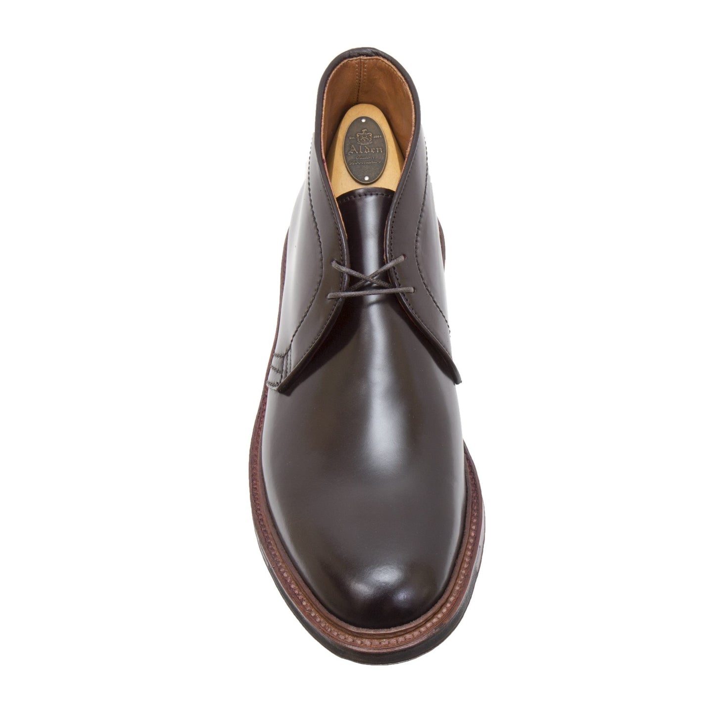The D5706C - Antique Chukka Boot by Alden Madison features a refined dark brown Shell Cordovan design with a simple lace-up front, single side seam, and sturdy contrasting brown sole. It is elegantly photographed from above on a white background.