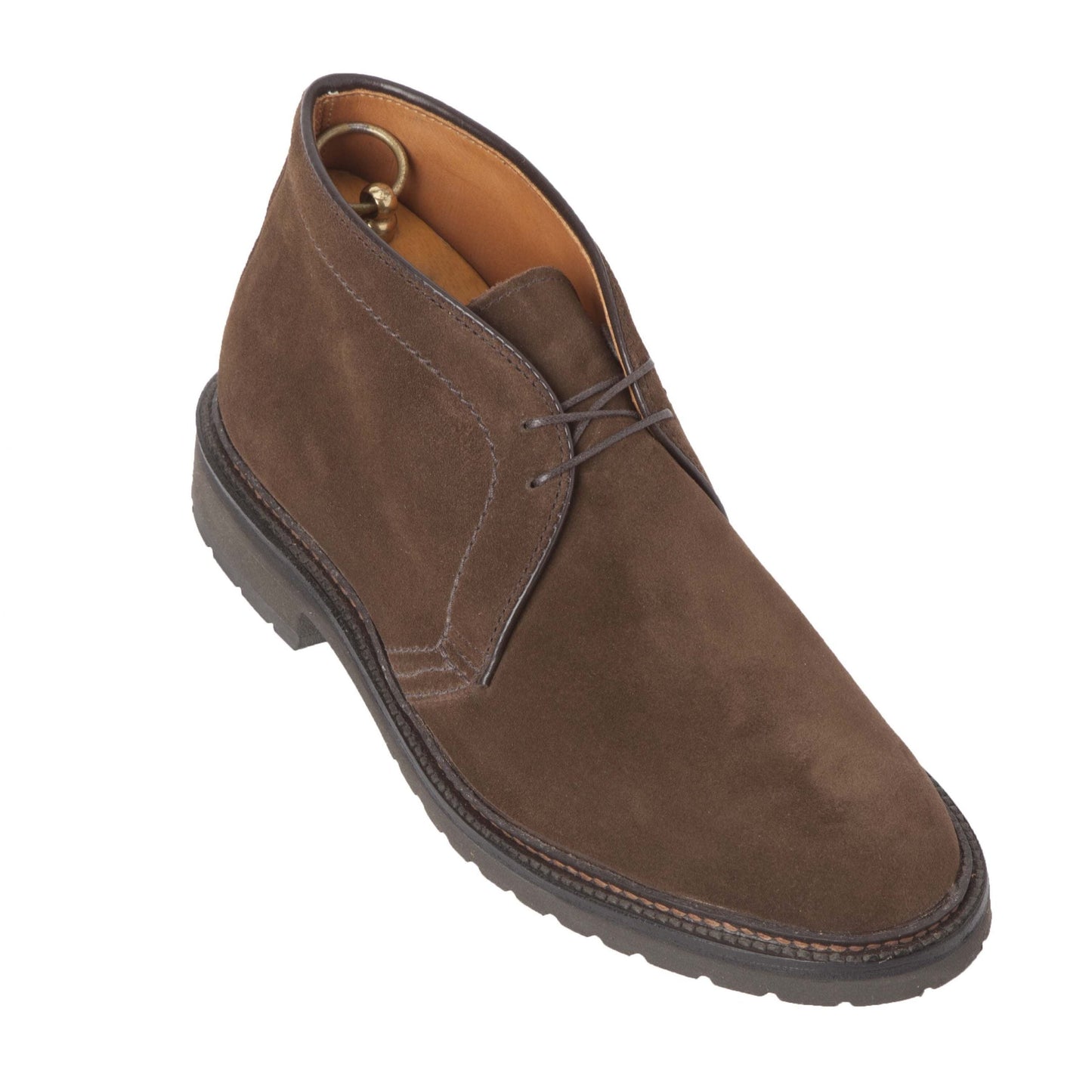 The Alden Madison 1273S - Chukka Boot in Brown Suede features dark laces and a sturdy lug rubber sole, displayed at an angle against a white background.