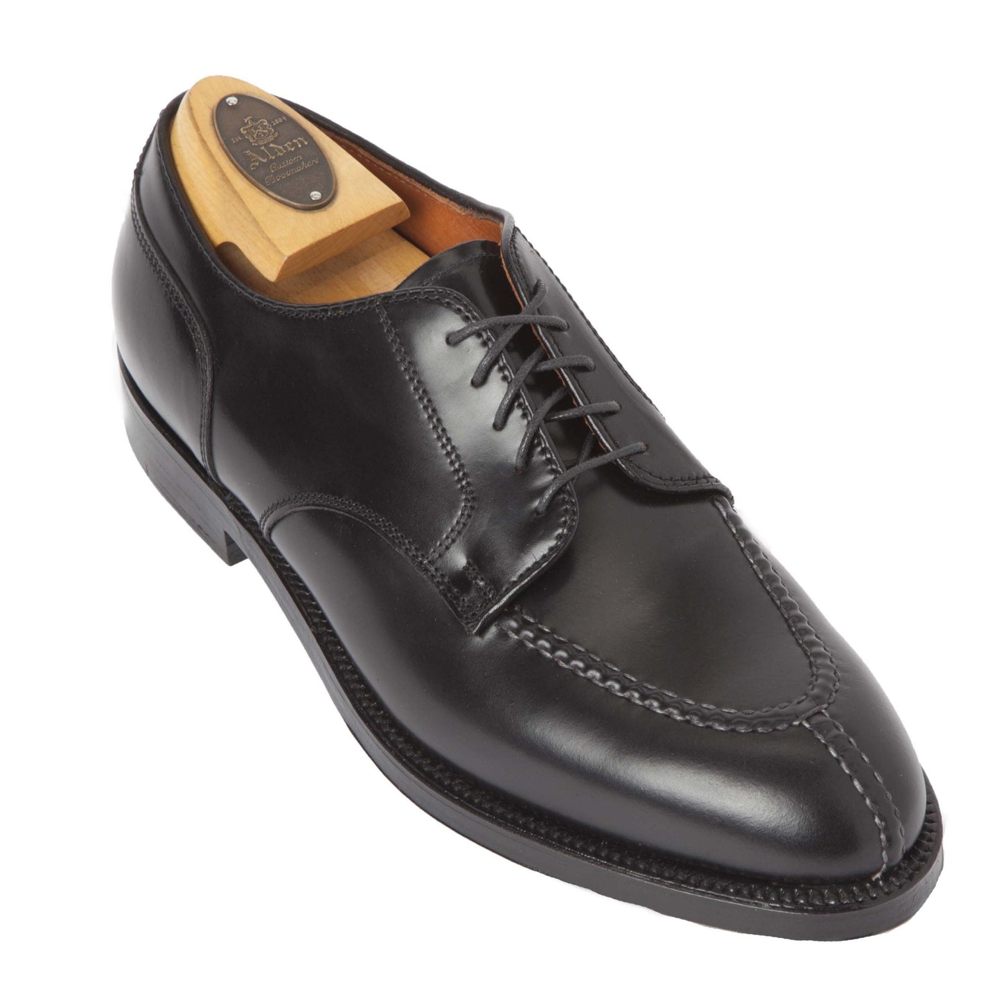 The Alden Madison 2211 - Norwegian Split Toe Blucher in Black Shell Cordovan features decorative hand stitching, a lace-up design, and is shown with a wooden shoe tree inserted to highlight its polished finish and elegant craftsmanship.