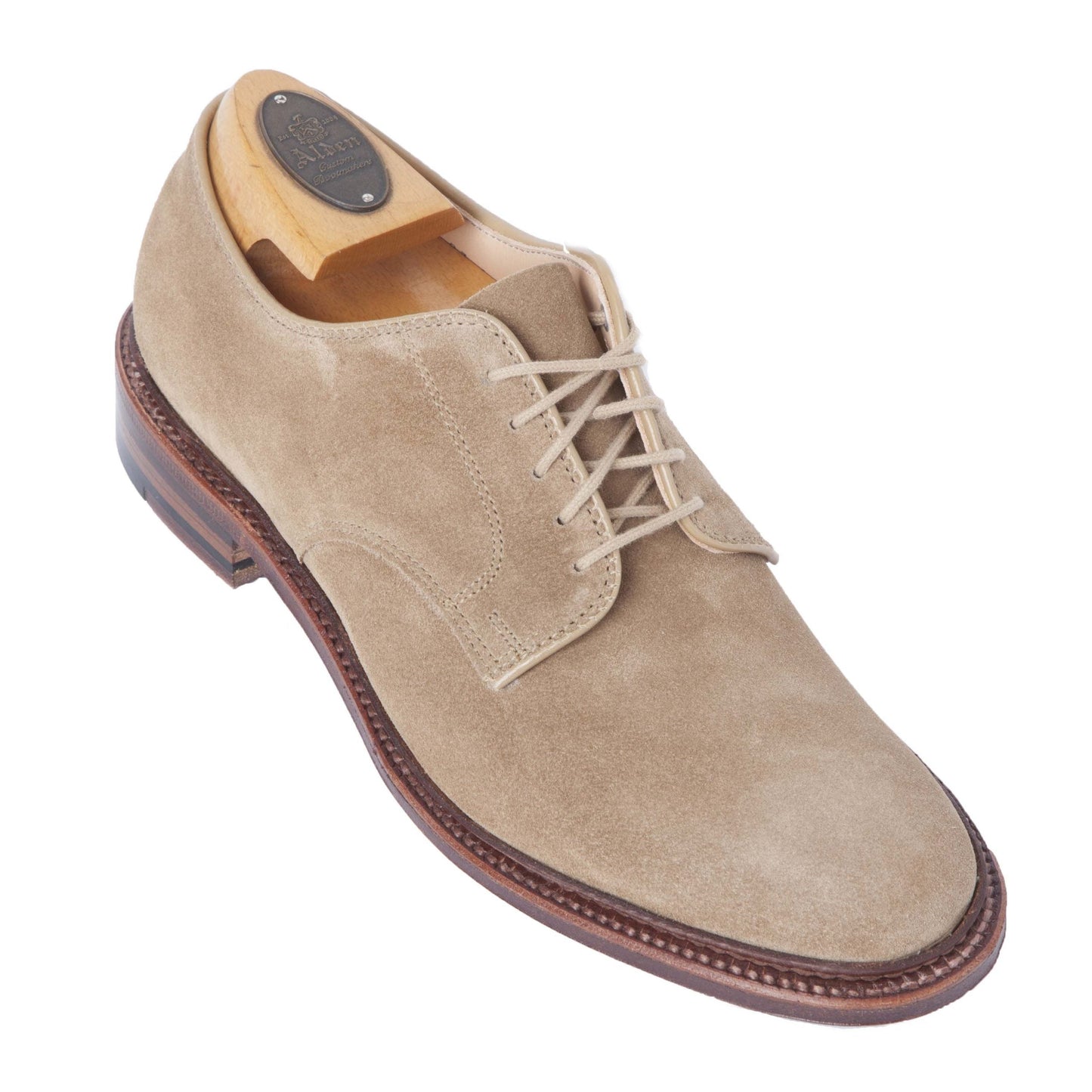 The Alden Madison 29332F Unlined Plain Toe Blucher features tan suede, a leather sole, and a wooden shoe tree crafted on the Barrie Last. With beige laces, smooth upper, and dark brown sole with intricate stitching, its elegantly displayed on a white background.