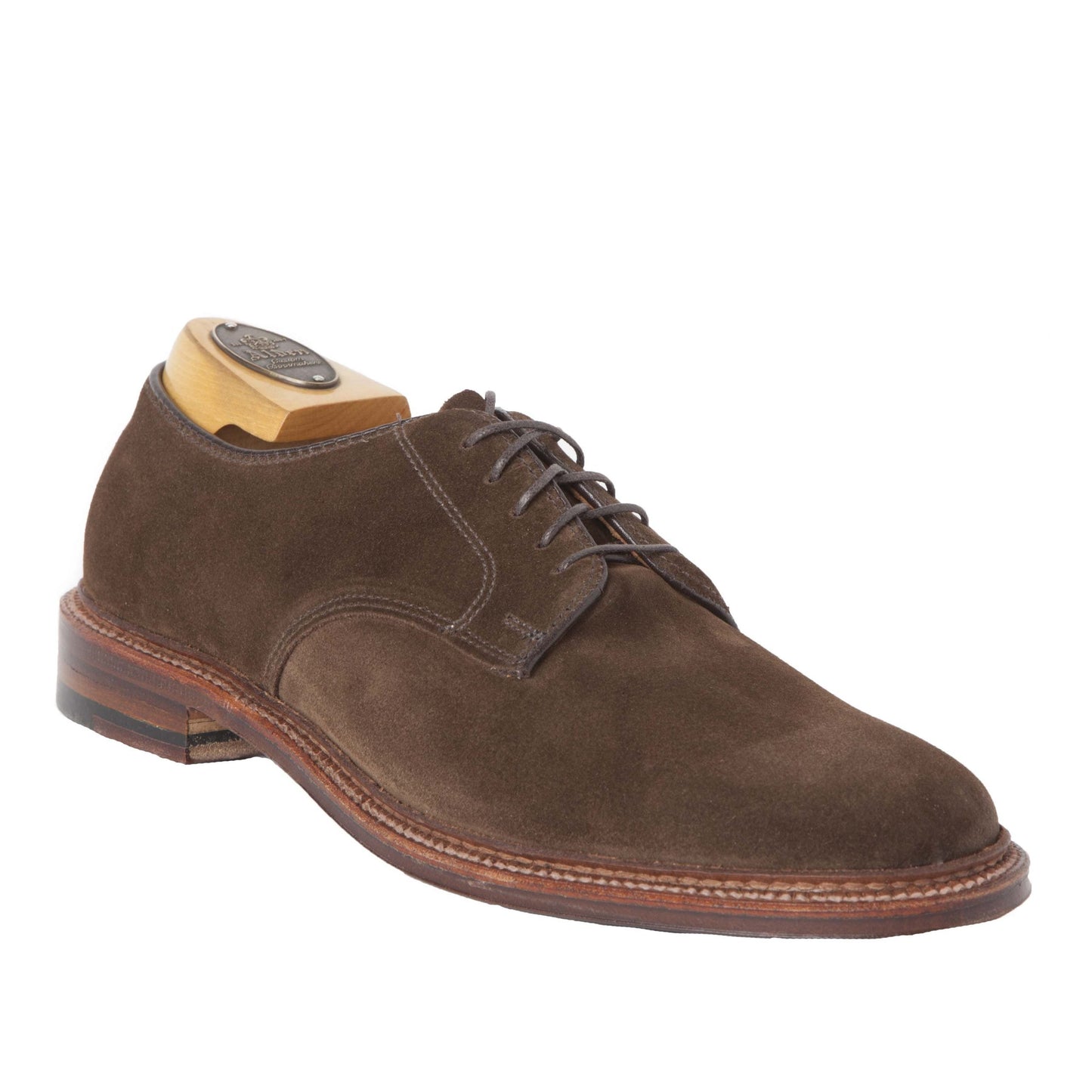 The Alden Madison 29335F - Unlined Dover in Brown Suede is a classic lace-up shoe on a Barrie Last, featuring visible Storm Welt stitching, a low stacked leather heel, and comes with a wooden shoe tree inserted for elegance and style.