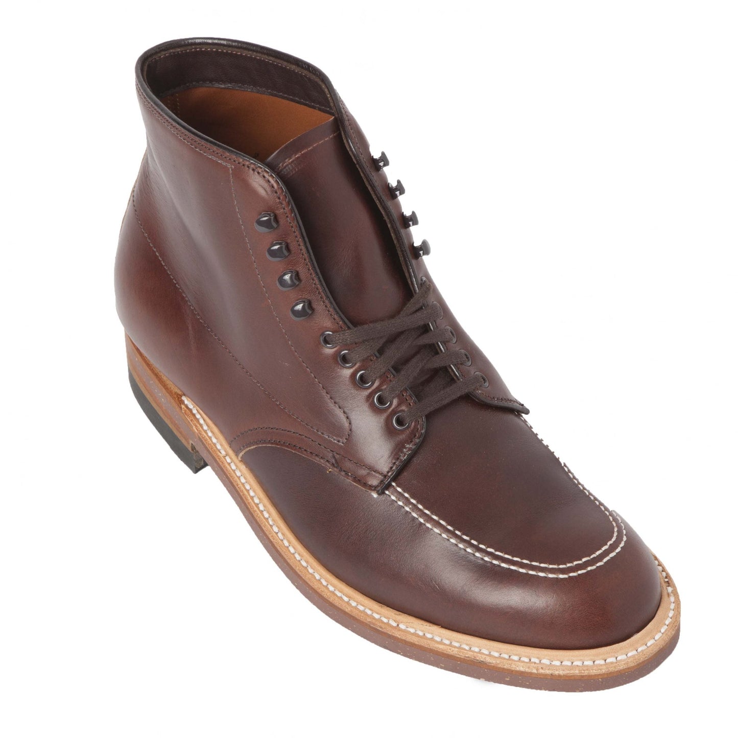 The Alden Madison 403 - Indy Boot in Brown Chromexcel is a brown leather boot with black laces, decorative stitching, and speed hooks for easy on-and-off. Its rugged cork sole complements its polished finish, showcasing a classic and sturdy design.
