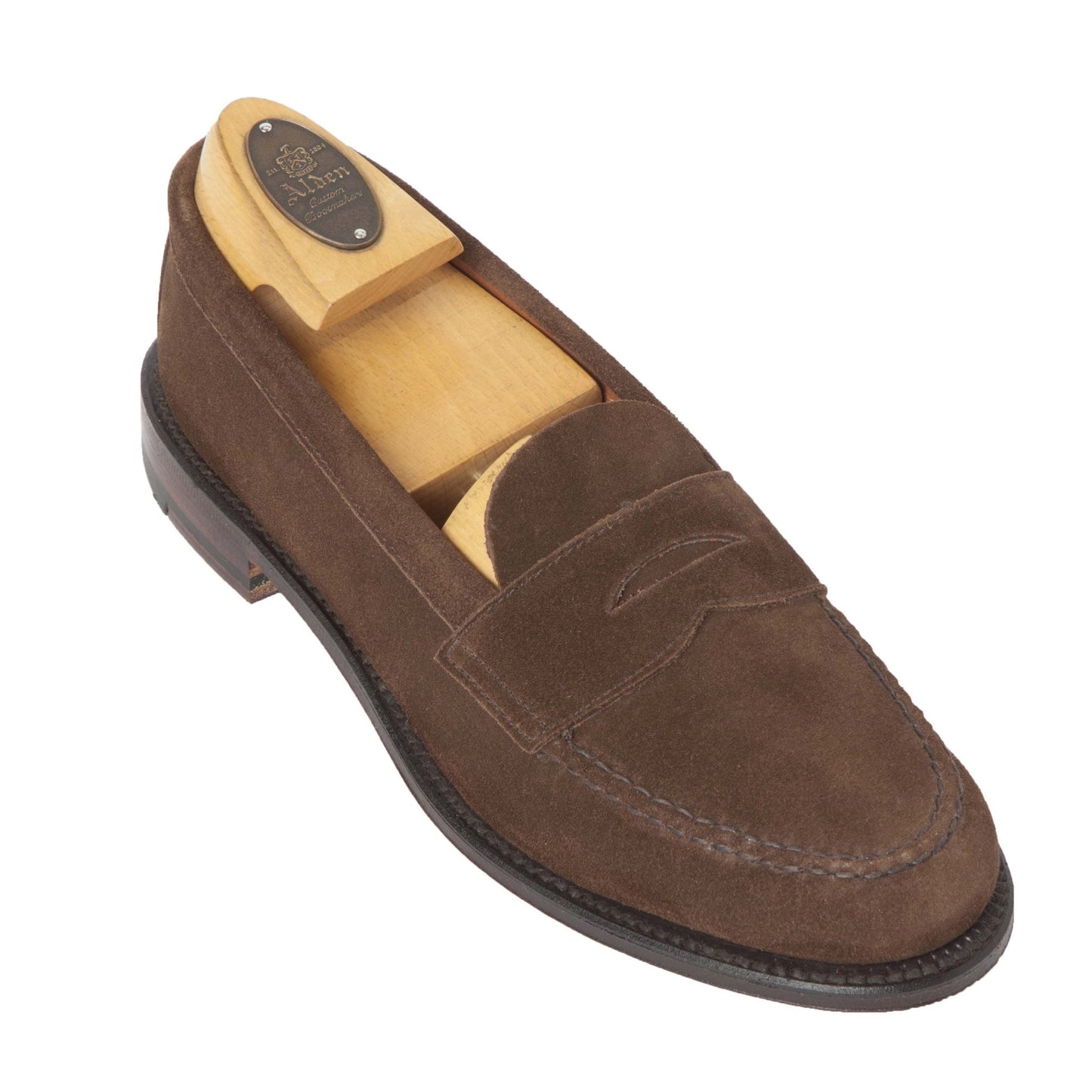 The Alden Madison 6245F - Unlined Leisure Hand Sewn in Brown Suede is eloquently displayed against a white background. This new loafer with a flex leather sole features exquisite hand stitching, a slightly raised heel, and includes a wooden shoe tree inside.