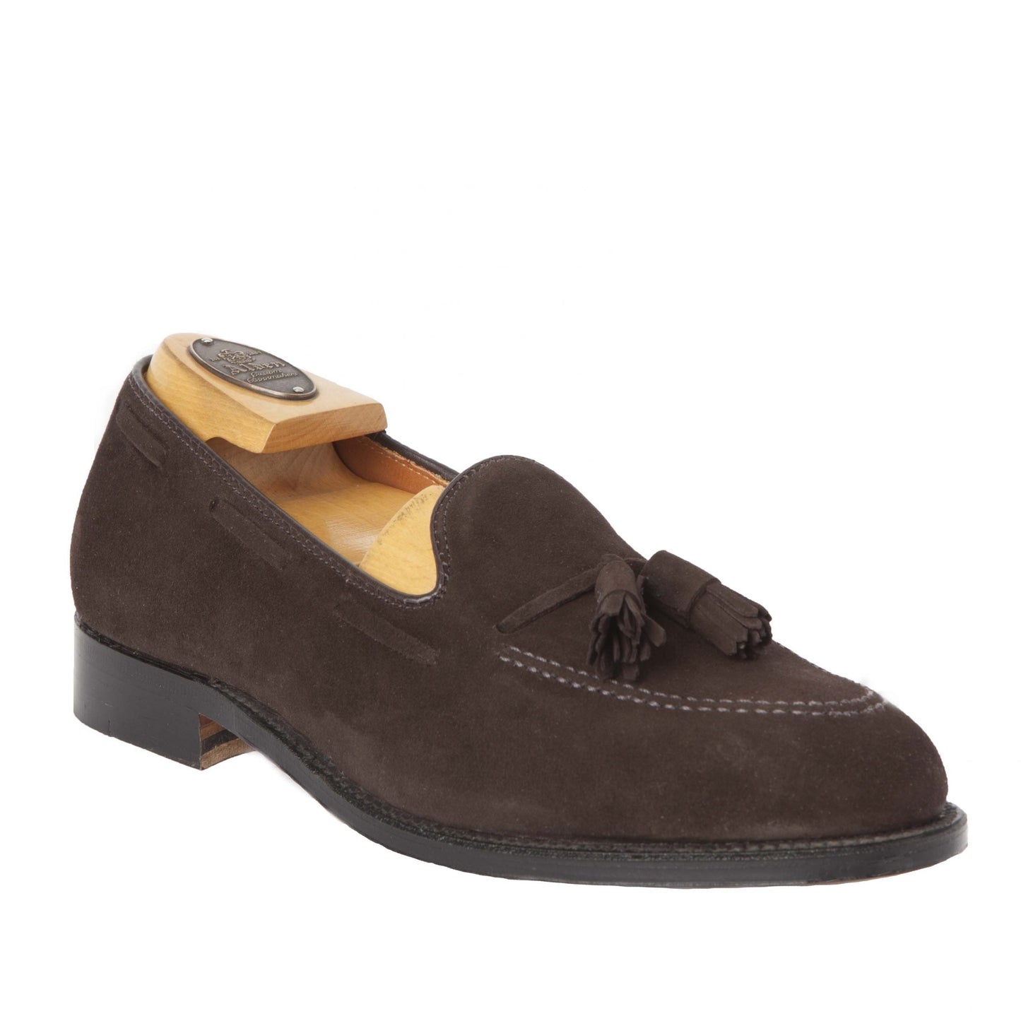 The Alden Madison 666 - Tassel Loafer in Brown Suede, crafted on the Aberdeen Last, highlights timeless style with tassels on the upper. Displayed with a wooden shoe tree, it features a leather sole against a crisp white background.