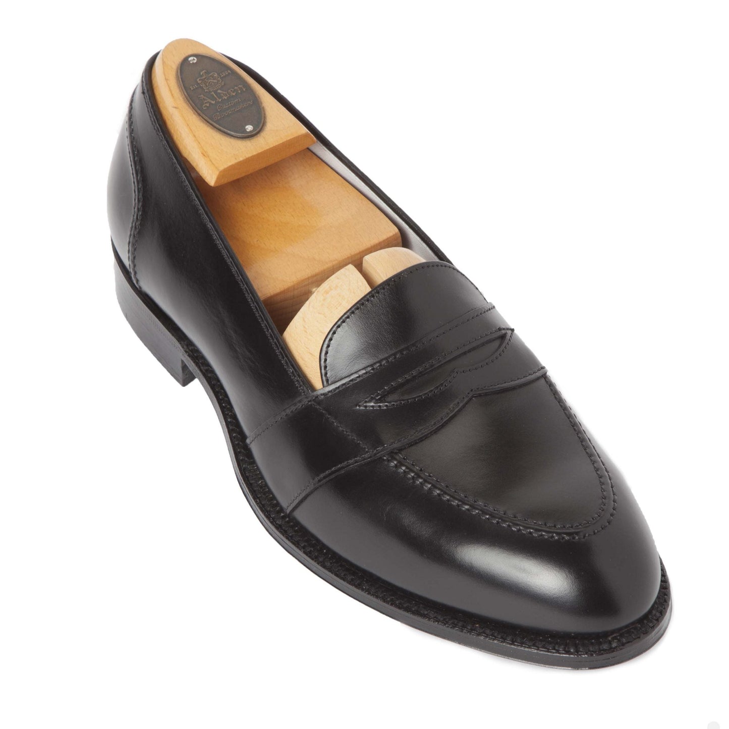 Alden Madisons 681 Full Strap Loafer in black calfskin showcases a sleek design with a wooden shoe tree inside for shape retention. Built on the Aberdeen last, it features a leather sole, low heel, and smooth finish—perfect for formal or smart-casual occasions.