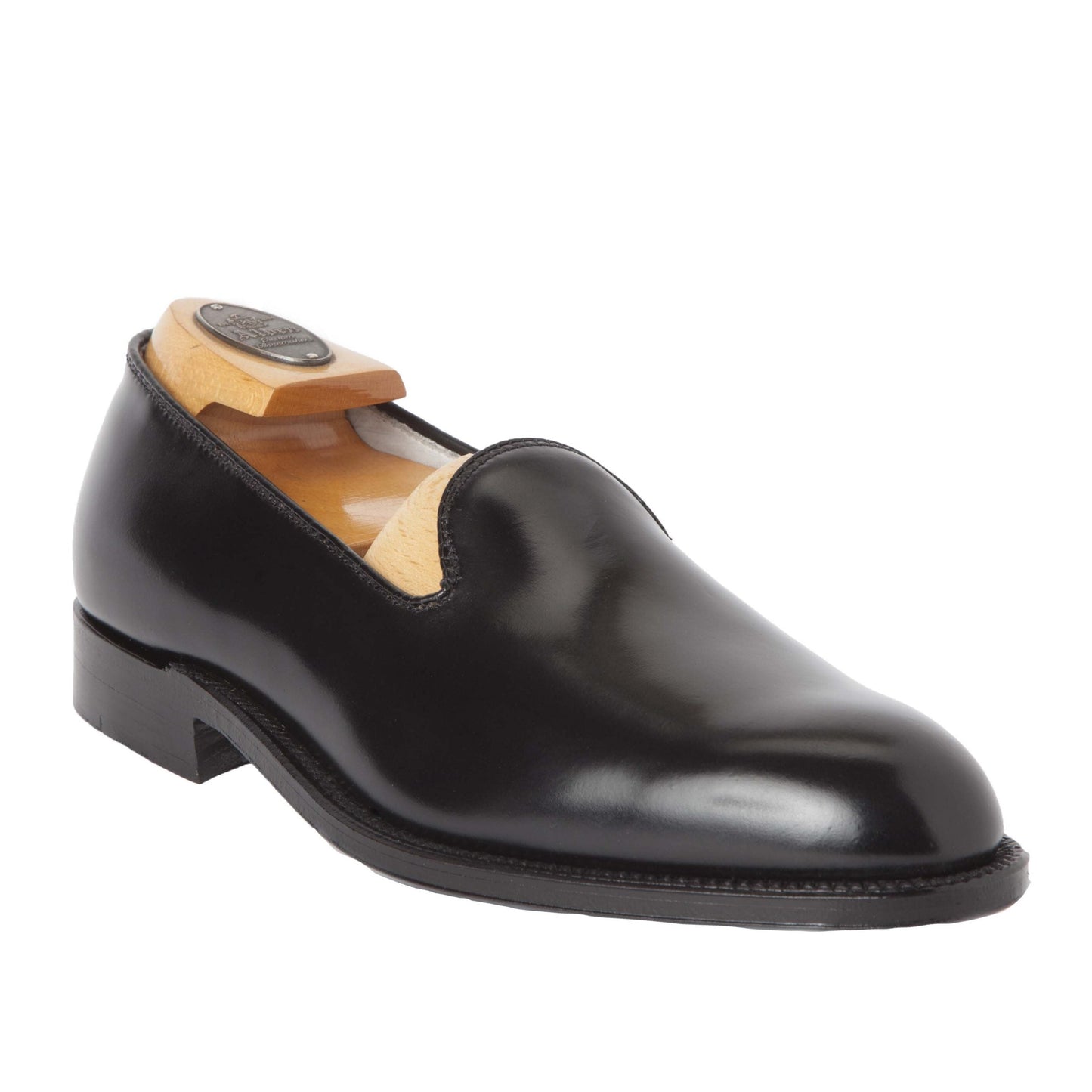The Alden Madison 8815 - Plain Toe SlipOn in Black Shell Cordovan, displayed on an Aberdeen Last with a wooden shoe tree, features a low heel, round toe, and single leather sole for timeless elegance.