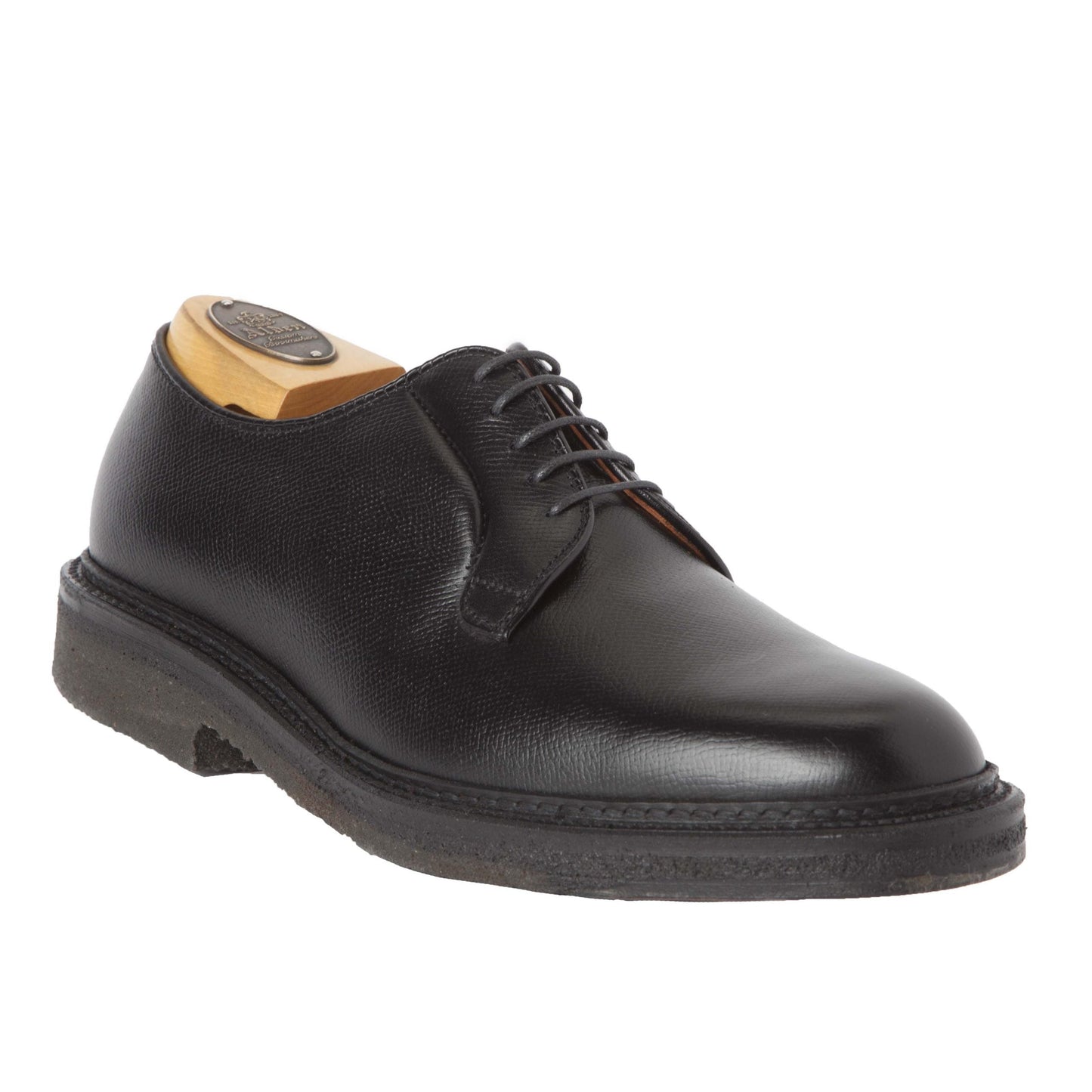 The Alden Madison 949 - All Weather Walker in Black Alpine Grain features textured black calfskin, a black sole, and black laces, shown here with a wooden shoe tree inside.