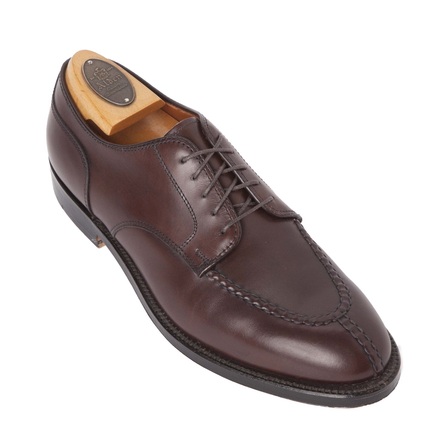 The Alden Madison 968 - Norwegian Split Toe Blucher in brown calfskin, featuring hand stitching, a black sole, and a wooden shoe tree inside, is displayed on a white background.