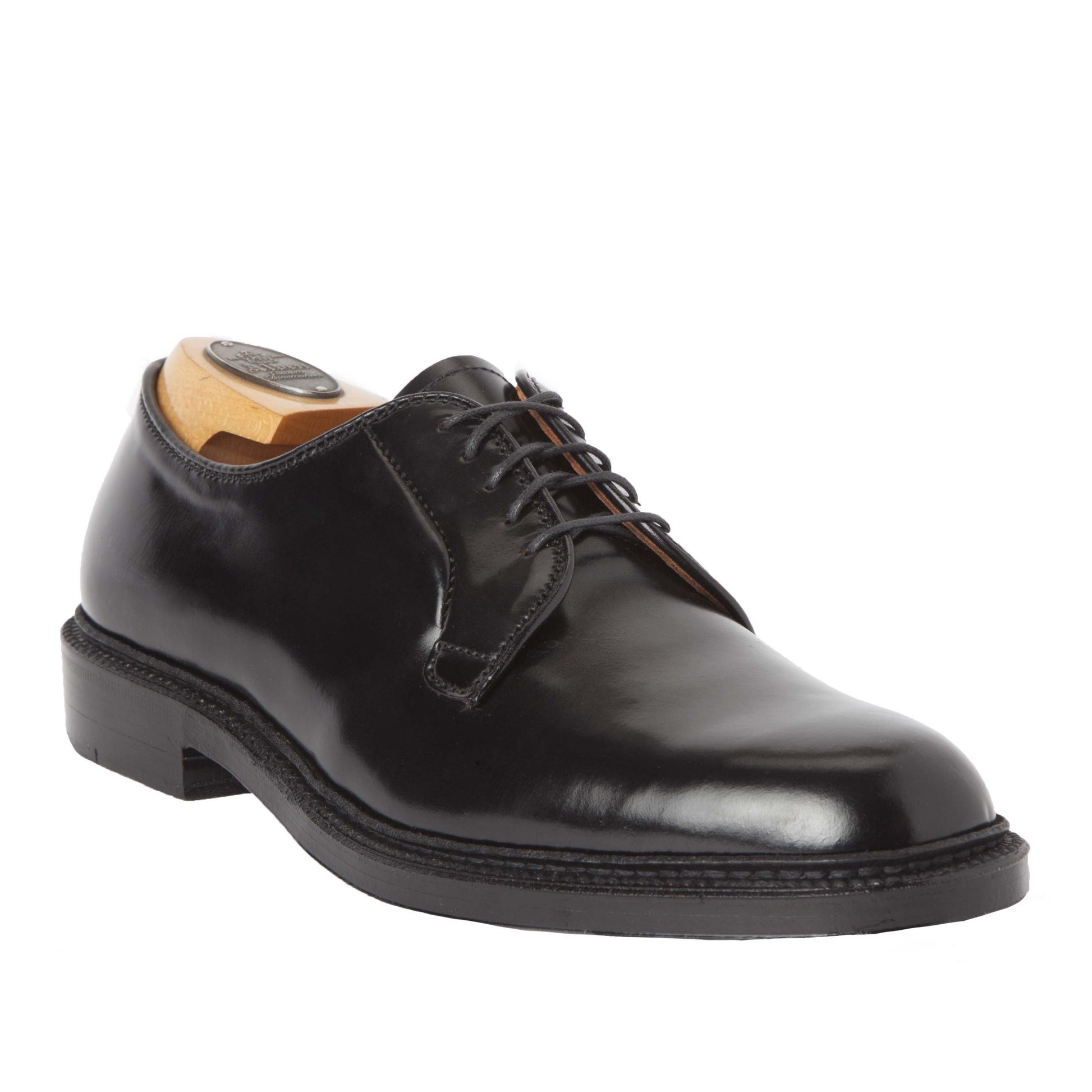The Alden Madison 9901 - Plain Toe Blucher Black in Shell Cordovan is shown angled against a white background. The shoe, with a polished finish and low heel on Double Oak Leather Sole, includes a wooden shoe tree to maintain its shape.
