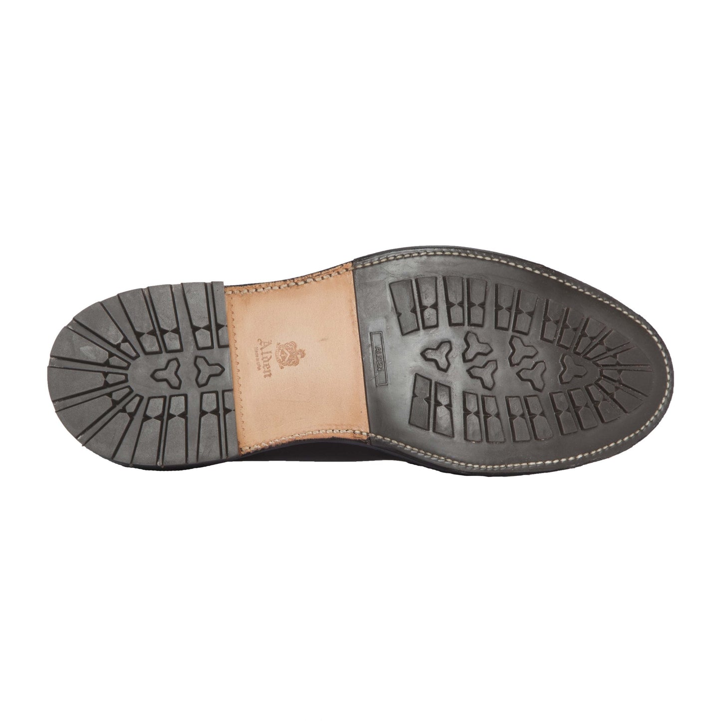 The image shows the sole of the Alden Madison 4465HC Wing Tip Boot in Black Shell Cordovan, featuring black rubber tread, a tan leather midsection, and the Alden logo embossed near the heel.