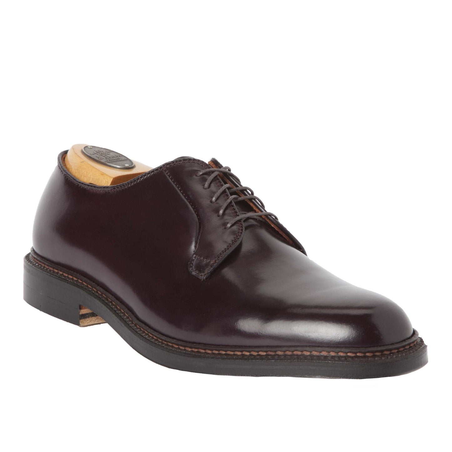 The Alden Madison 990 - Plain Toe Blucher in Color 8 Shell Cordovan is a polished, dark brown leather dress shoe with black laces and a Double Oak Leather Sole, featuring visible stitching, low heel, and includes a wooden shoe tree for an elegant finish.