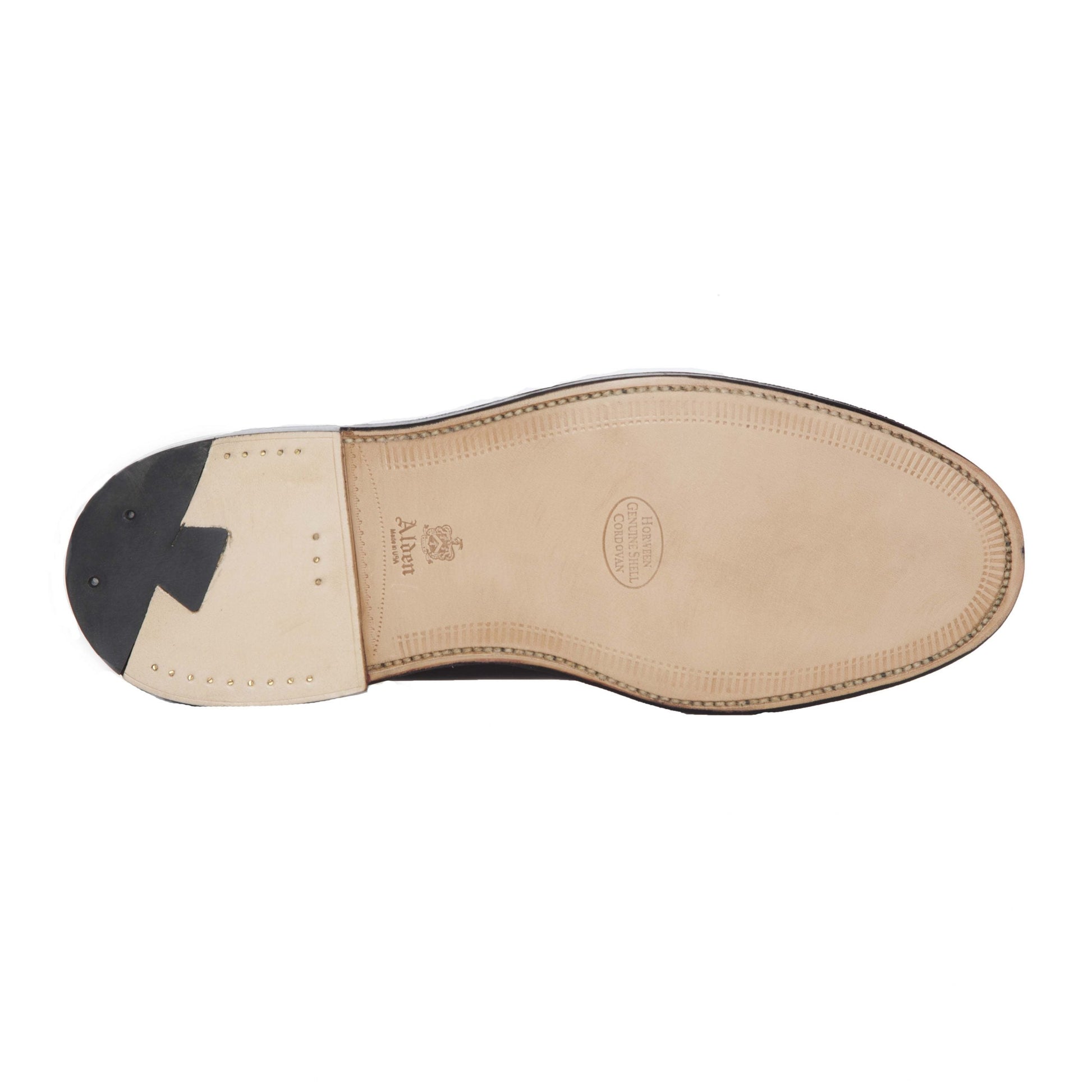 The image highlights the sole of the Alden Madison 984 - Leisure Hand Sewn in Burgundy Calfskin shoe. Made from smooth, light Oak Leather with a sleek black heel, it features visible edge stitching and embossed details near the center and heel, enhancing its impeccable design.