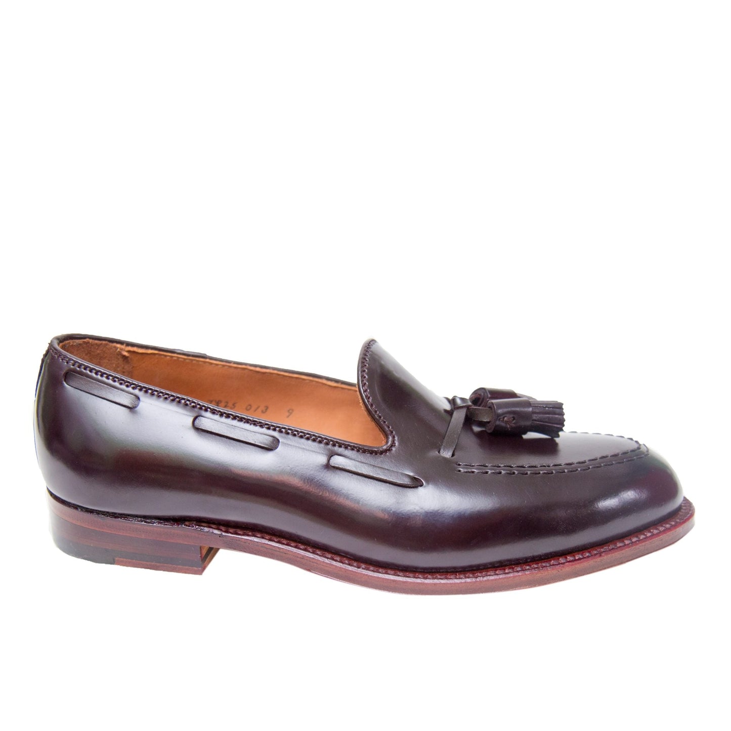 The Alden Madison D7103 is an Antique Tassel Loafer crafted from Color 8 Shell Cordovan, featuring detailed toe stitching and a low stacked wooden heel in polished dark brown leather.