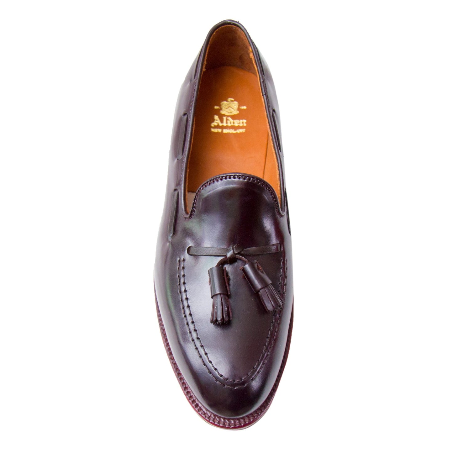 Top view of the D7103 - Antique Tassel Loafer in Color 8 Shell Cordovan by Alden Madison, showcasing tassels and stitching on the Aberdeen Last. It features Alden New England branding on the insole and is accentuated by antique edging for a classic look.