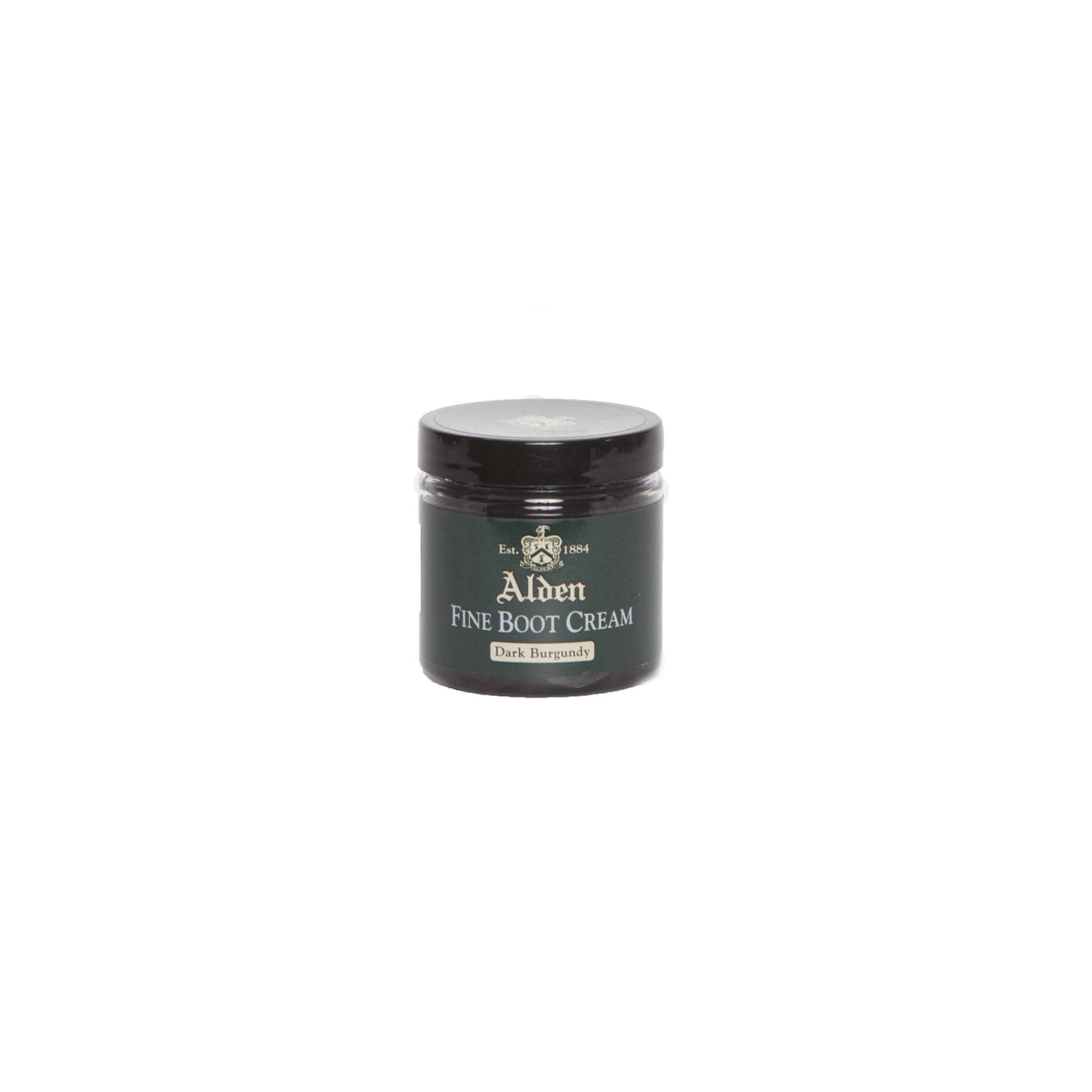 A small jar of Alden Boot Cream by Alden Madison, in Dark Burgundy, ideal for enhancing calfskin leathers. It has a black lid and label with white and gold text, featuring a crest logo. The jar is centered on a plain white background.