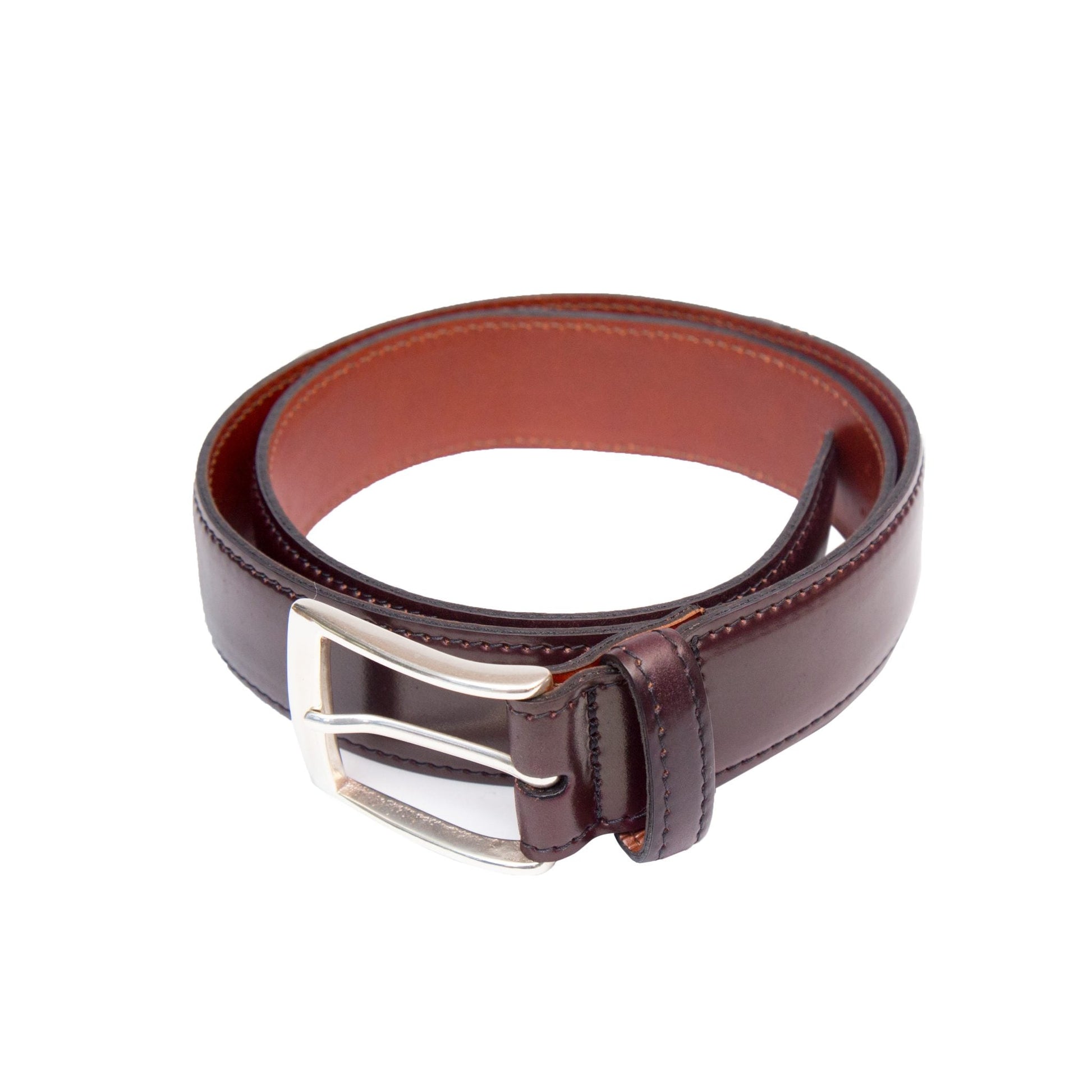 A coiled Alden Madison A501 belt in Color 8 lies on a white background. It features a dark brown 35mm-wide leather crafted from Horween Shell Cordovan and a silver rectangular nickel buckle, highlighting its exquisite texture.