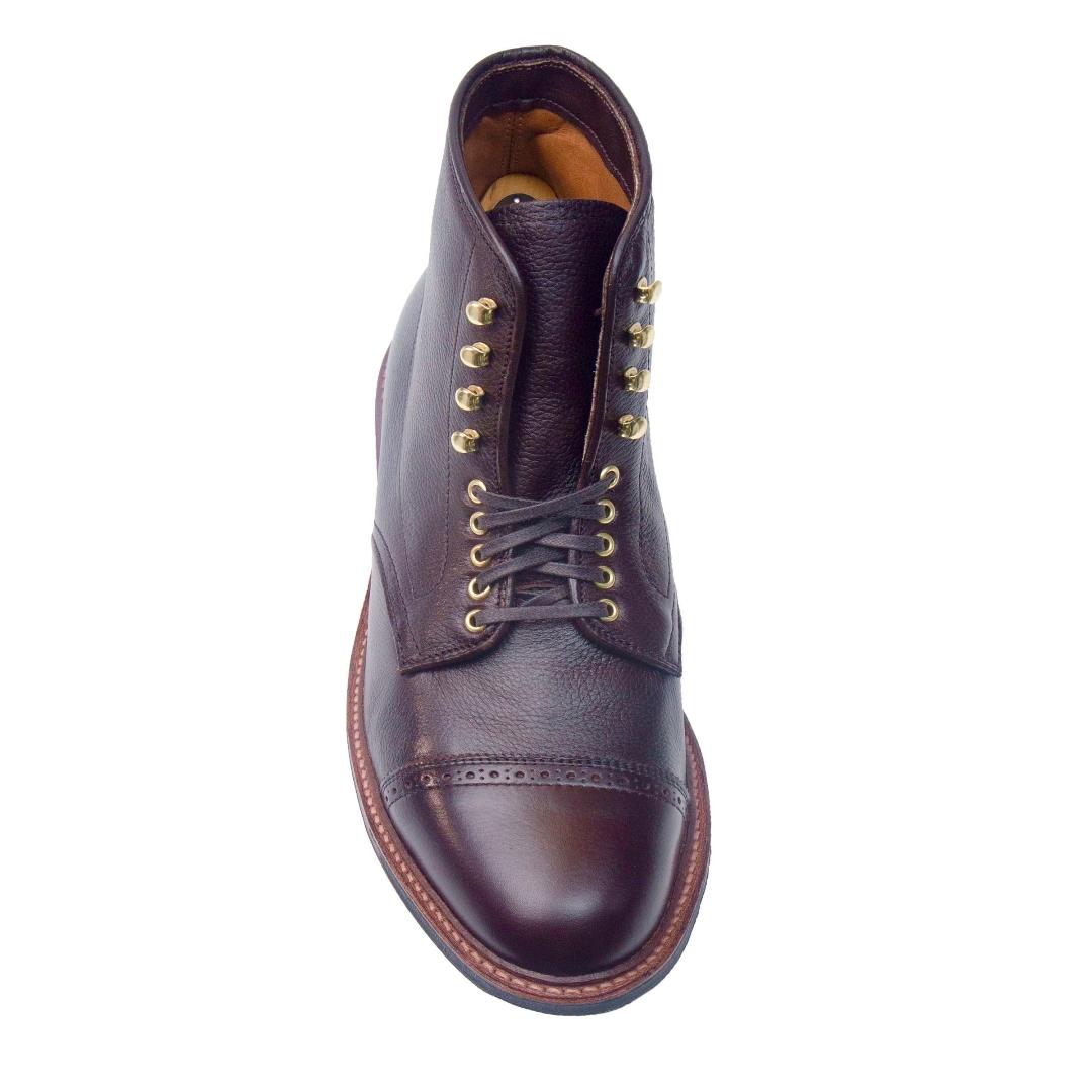 An overhead view shows a single Alden Madison D9819HC - Jumper Boot in Regina Brown Grain, featuring laces, brass eyelets, and a rounded toe. The boot has a slightly darker toe cap with visible stitching on a durable Commando Sole.