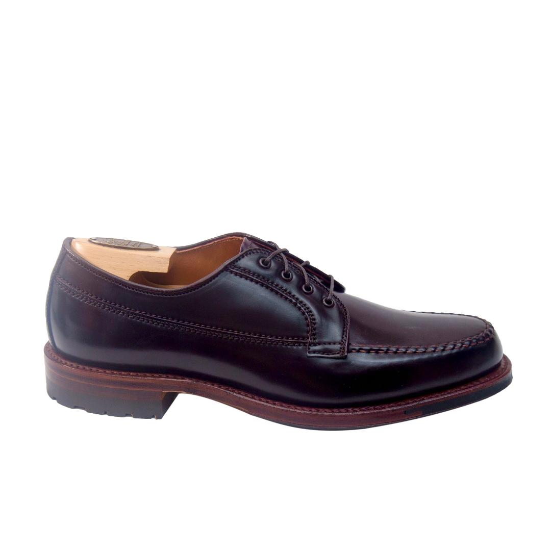The Alden Madison D9613C - Ranger Mocc in Color 8 Shell Cordovan is shown from the side with a wooden shoe tree inside. This dark leather dress shoe has laces, stitched detailing, a low heel, and an antique edge on a white background.