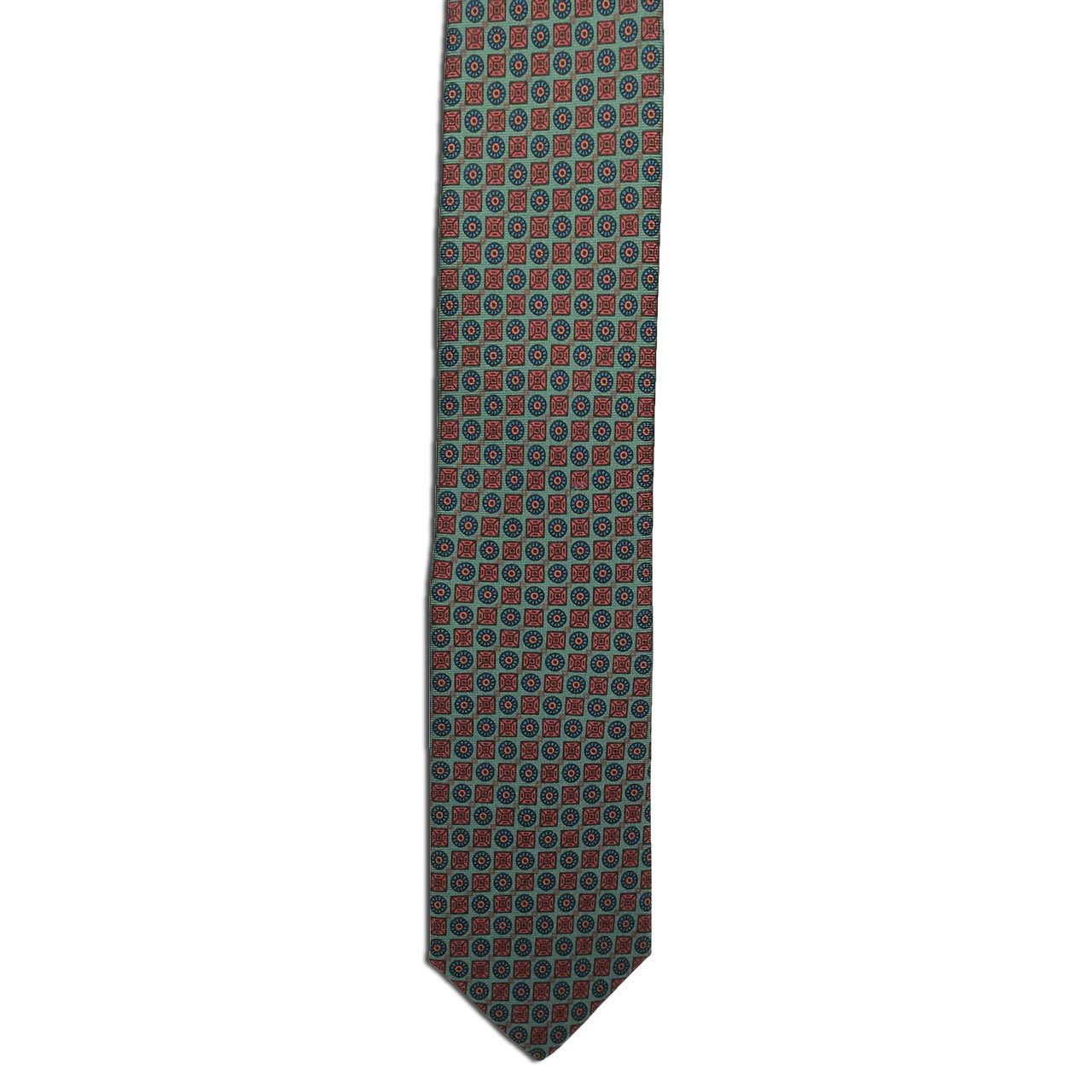 The Green Small Print tie by Alden Madison features a classic repeating geometric pattern of small circles and squares in red, blue, and green tones on a muted background.