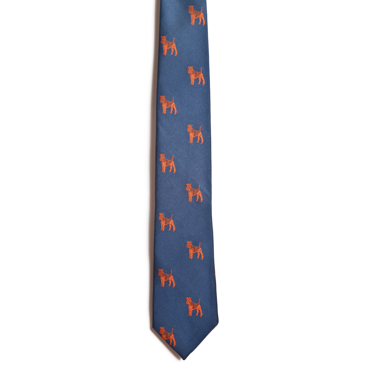 The Alden Madison Airdale Terrier is a blue jacquard silk dog necktie featuring a repeating pattern of small orange dogs embroidered across the fabric.