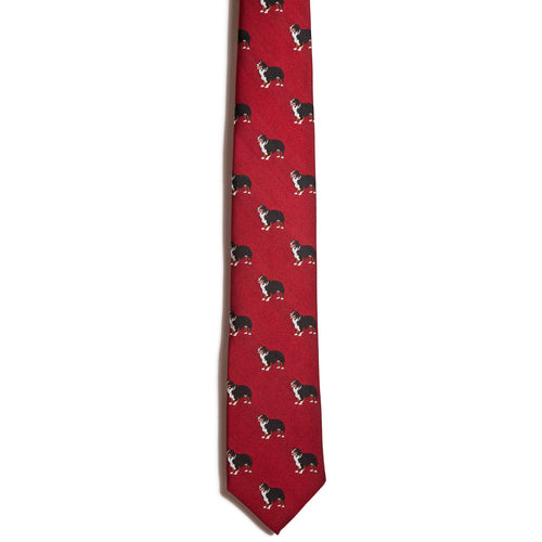 Alden Madisons Australian Shepherd necktie is a deep red piece made from 100% silk, showcasing small black and white bulldogs in a playful jacquarding pattern.