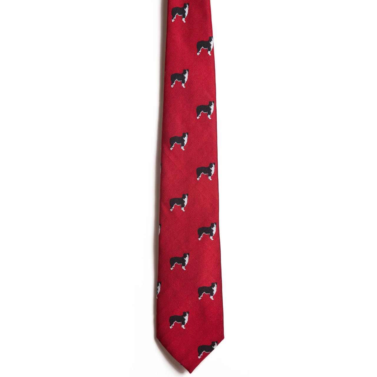 The Alden Madison Border Collie is a red, 100% silk necktie featuring a jacquard pattern of black and white dogs resembling Border Collies evenly spread across its surface.