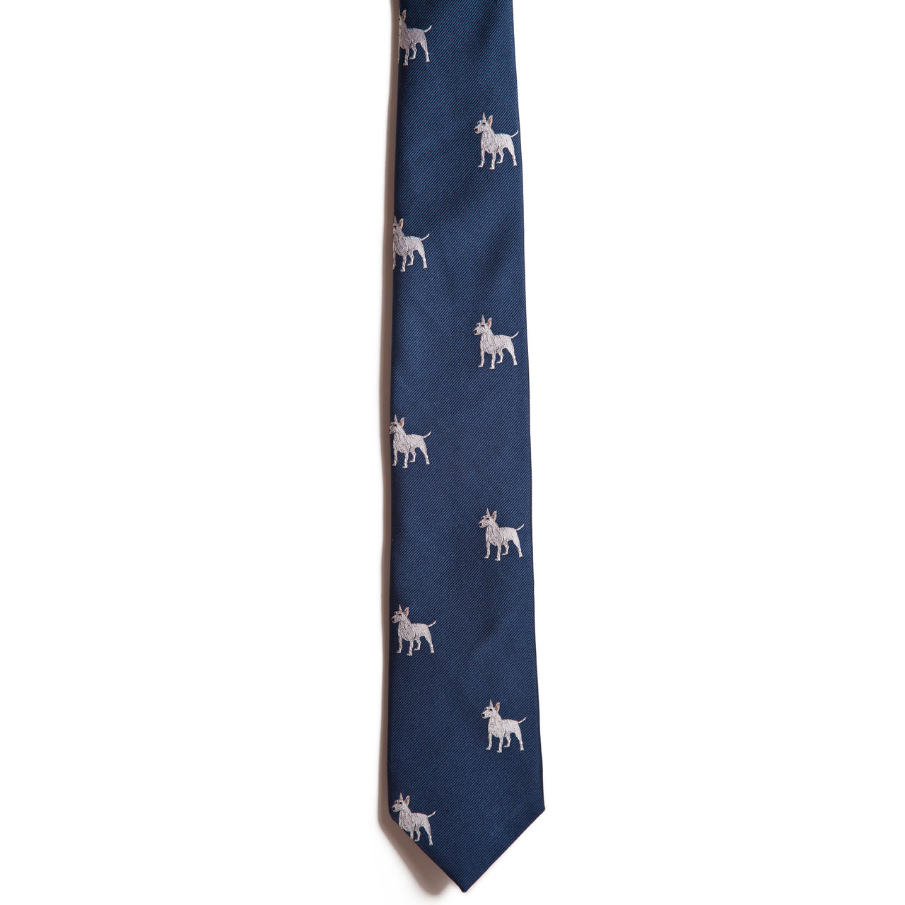 The Alden Madison English Bull Terrier is a navy blue silk jacquard tie featuring a repeating pattern of small, light-colored English Bull Terrier dog illustrations on a white background.