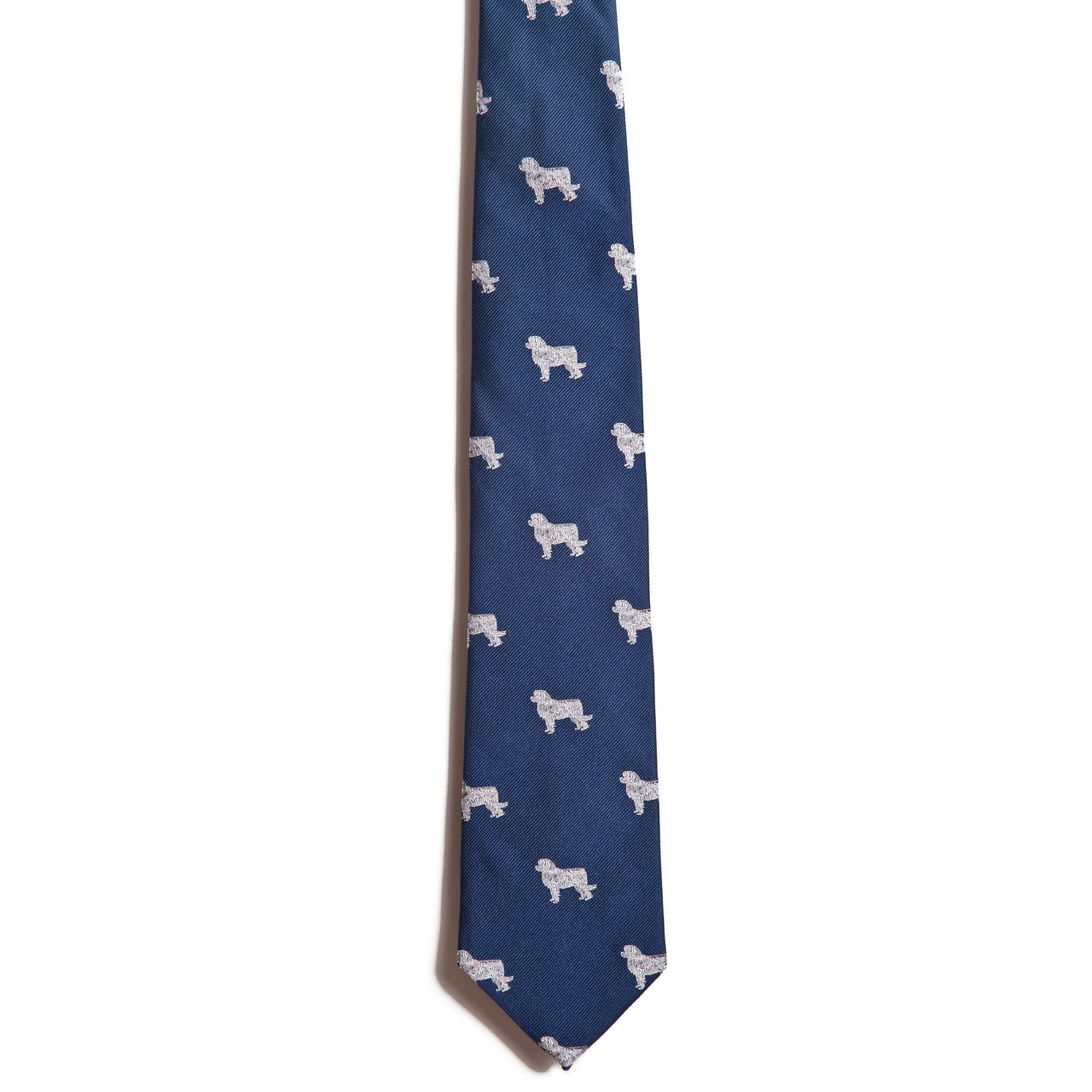 The Alden Madison Great Pyrenees necktie is 100% silk, featuring an exquisite jacquard design of small white dog silhouettes in blue.