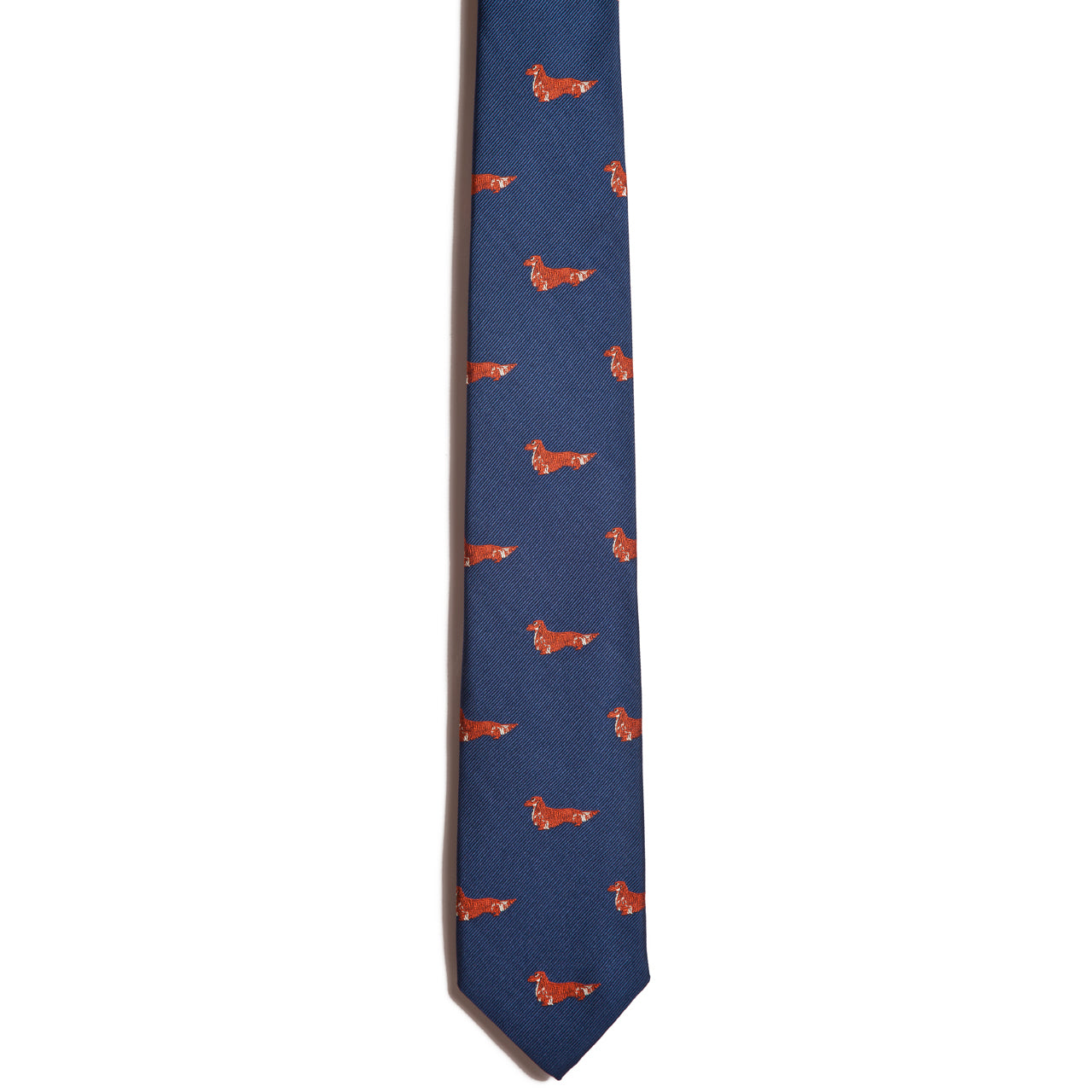 The Alden Madison Dachshund (longhair) necktie features a blue jacquard design with small, evenly spaced red dachshund silhouettes, shown on a white background.