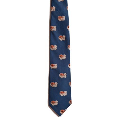 Alden Madison Pekingese Blue Silk Jacquard Tie features a repeating pattern of small brown and white Pekingese dogs—perfect for enthusiasts of this beloved breed.