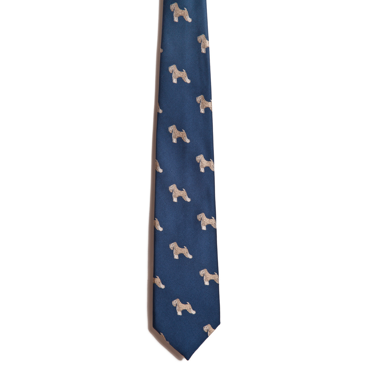 The Alden Madison Soft Coated Wheaten Terrier tie is blue silk and features a repeating pattern of small, light brown Wheaten Terrier illustrations.