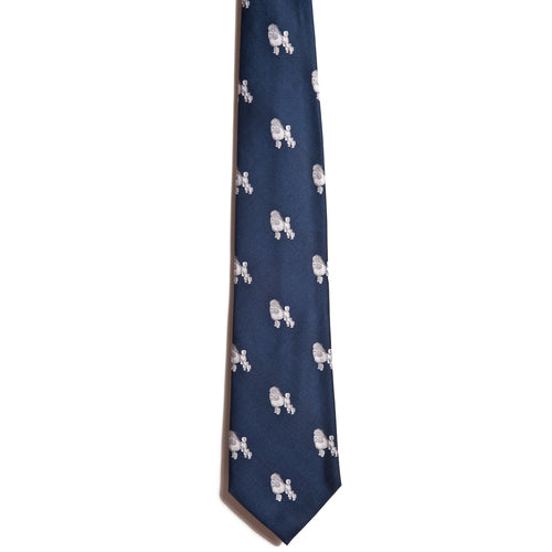 Alden Madisons White Poodle is a dark blue tie made of 100% silk, showcasing a jacquarding pattern with small, white embroidered turtles scattered across its fabric.