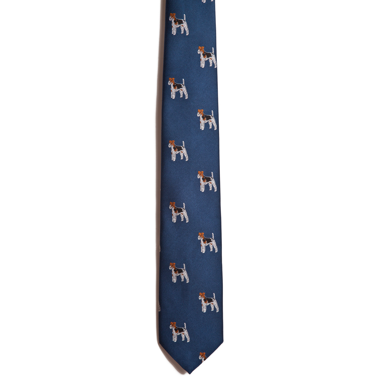 The Alden Madison Wire Haired Fox Terrier tie is a blue silk jacquard necktie with repeating white and brown Wire Haired Fox Terriers in profile—ideal for dog breed enthusiasts.