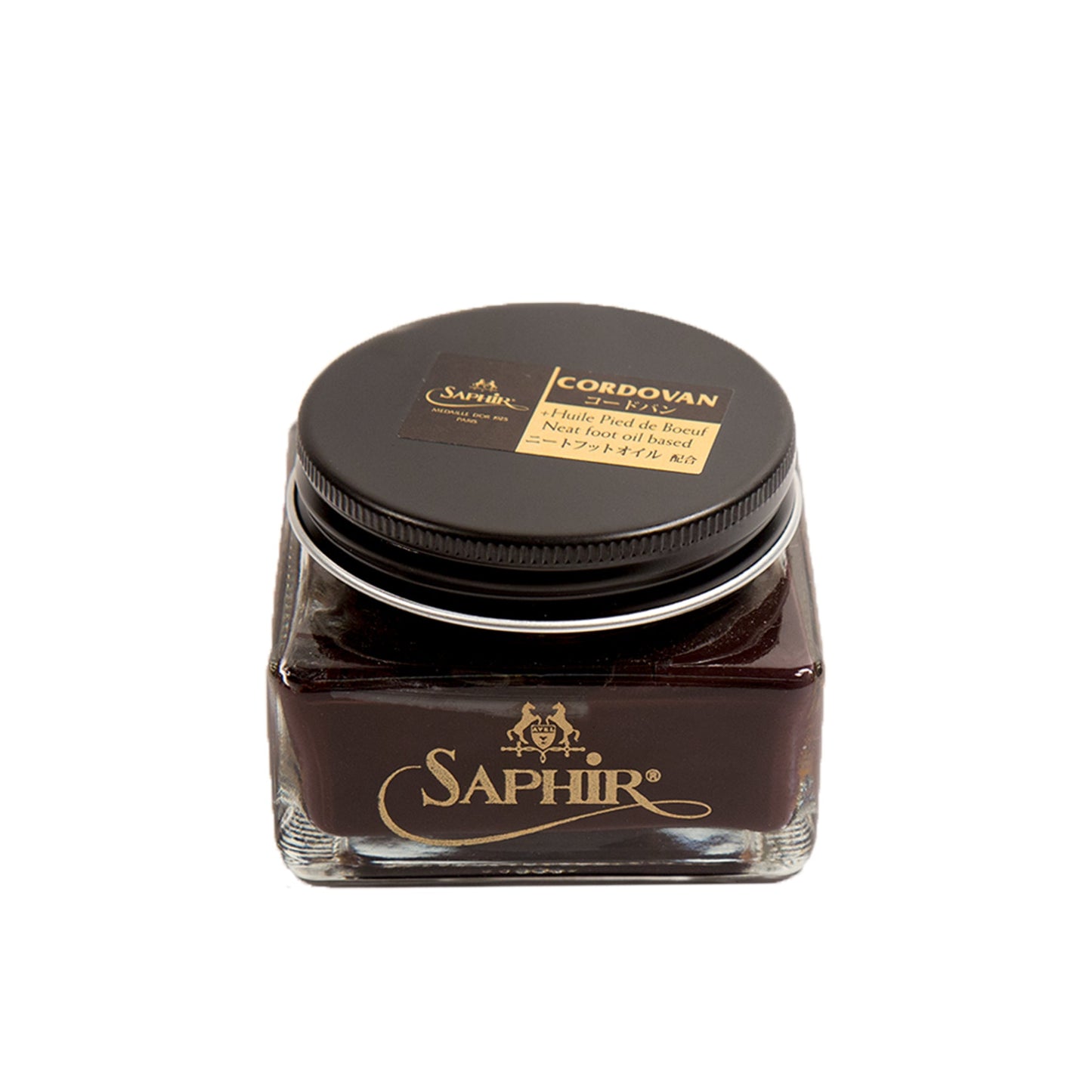 A glass jar of Alden Madison Saphir Cordovan Cream with a black lid is ideal for leather care. It contains a rich, dark brown polish specifically for Shell Cordovan Leather, featuring the brand name and product type elegantly in gold and beige text on the lid.