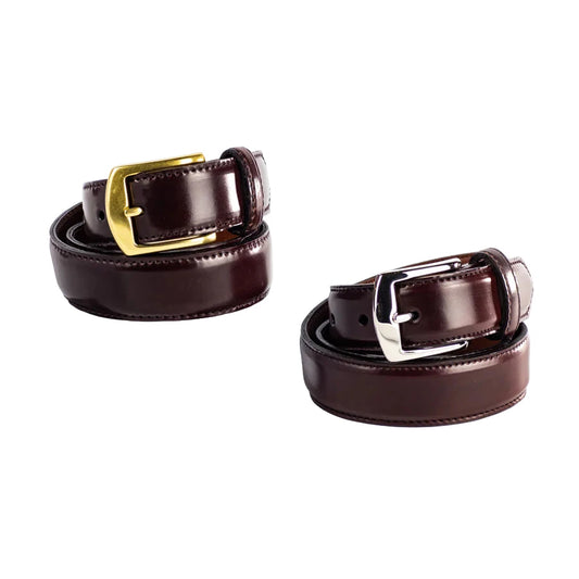 Two ALDEN SHOES Alden 32mm Color 8 Shell Cordovan Belts, one with a brass buckle and one with a nickel buckle, are coiled on a white background, with one displayed atop a clear acrylic block. Made in USA.