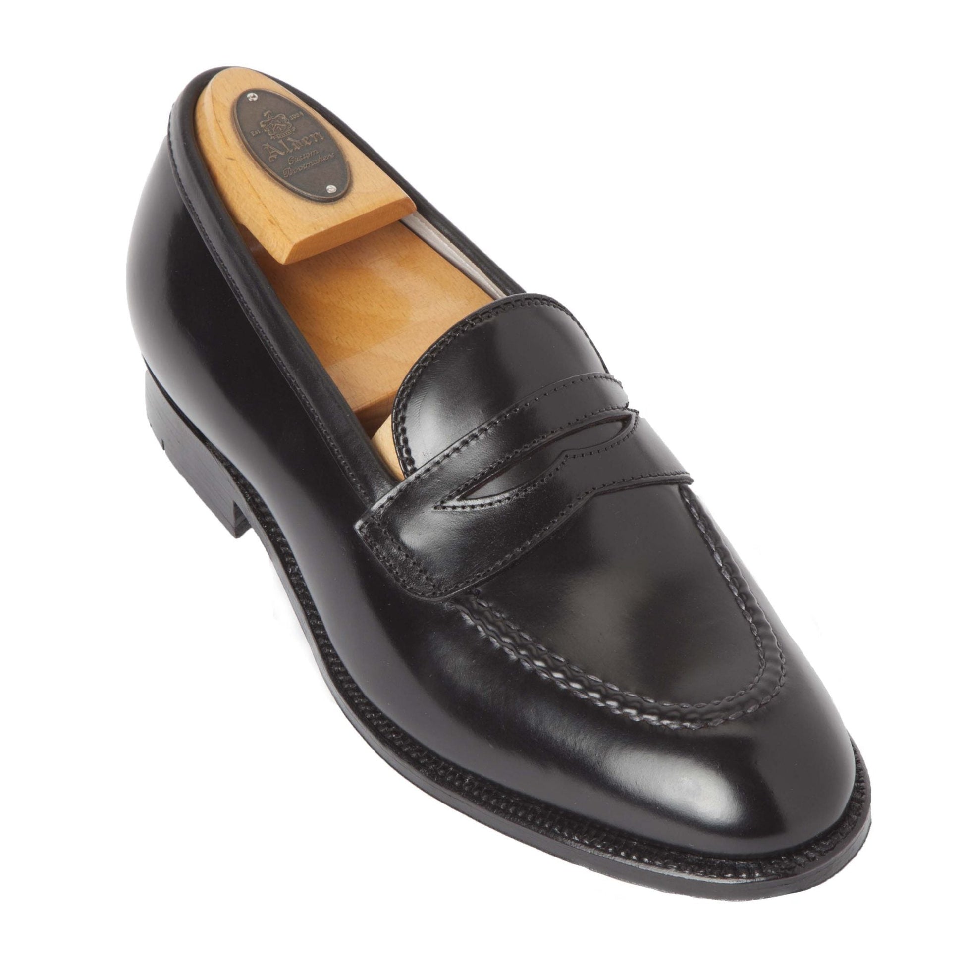 A single Alden Madison 67269 High Vamp Loafer in Black Shell Cordovan, crafted on the Grant Last with a Single Oak Leather Sole and visible stitching, is shown with a wooden shoe tree inserted on a white background.