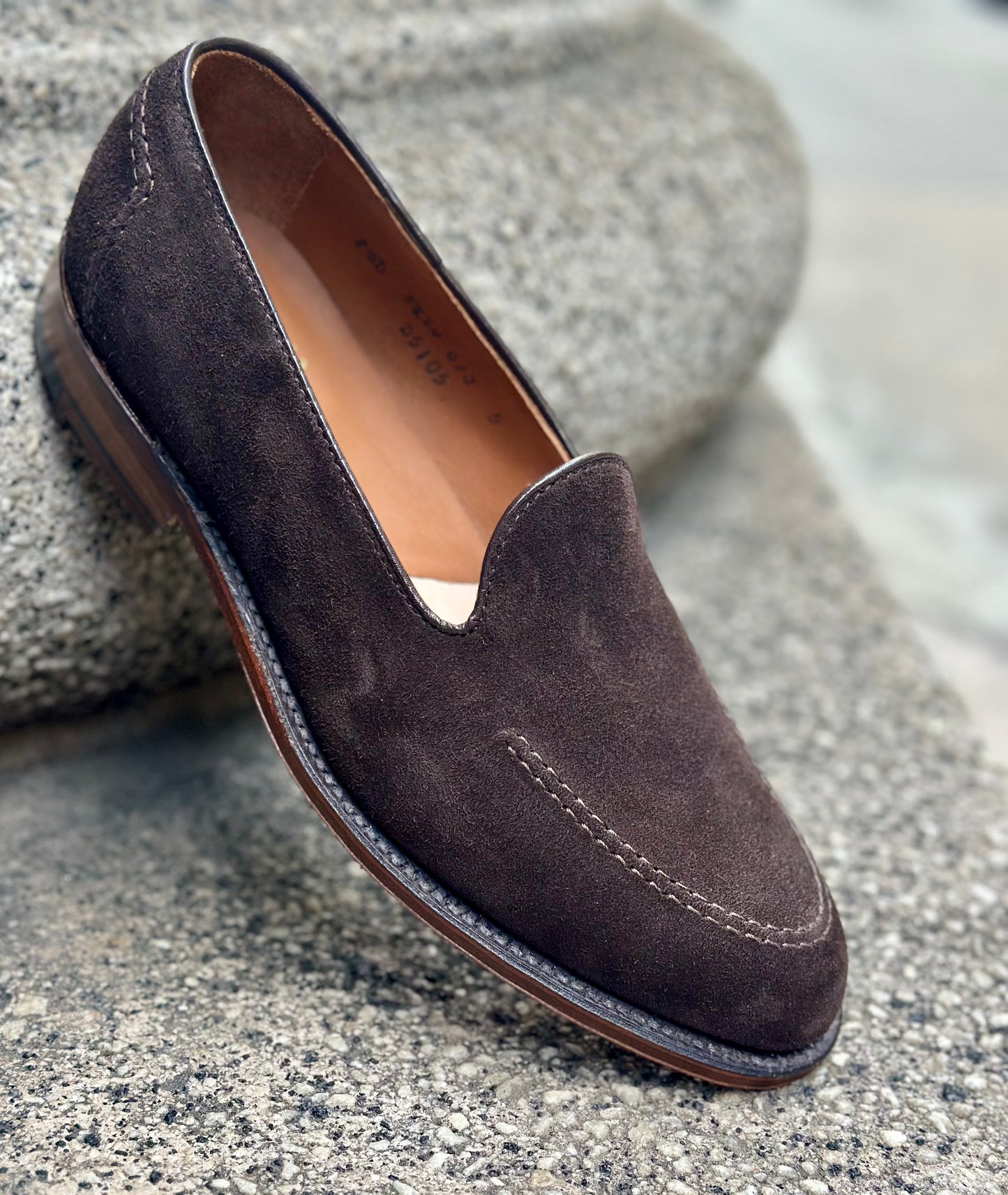The ALDEN SHOES D5105 - Vanderbilt in Dark Brown Suede, featuring visible stitching and a Flex Leather Sole, is displayed on a textured concrete surface.