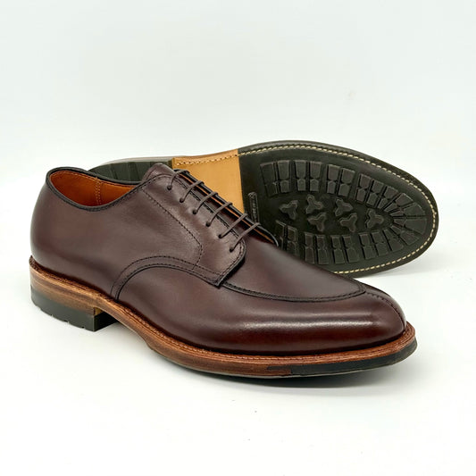 The ALDEN SHOES D6629C Brown Calf V Tip Blucher features a Commando Sole and polished finish. Crafted on the Barrie Last, one shoe stands upright while the other displays its tread pattern.