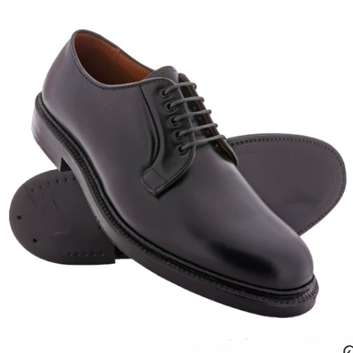 The ALDEN SHOES 9909 - Black Calfskin Plain Toe Blucher features polished black leather and a classic Barrie Last, shown with one shoe upright and the other on its side to display the sole.