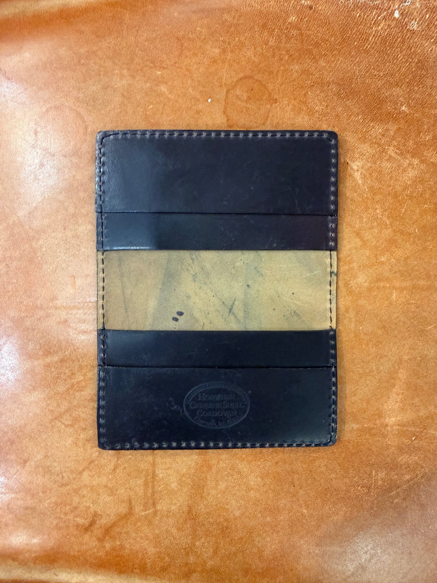 Alden Madison Credit Card Wallet in Shell Cordovan featuring dark leather, four slots, a center opening, and an embossed Horween logo on the bottom pocket.