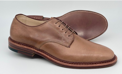 A pair of Alden Madison 29366F Unlined Plain Toe Dover shoes in Natural Chromexcel, featuring brown leather soles and Barrie Last shape—one upright, one on its side—highlighting detailed stitching against a white background.
