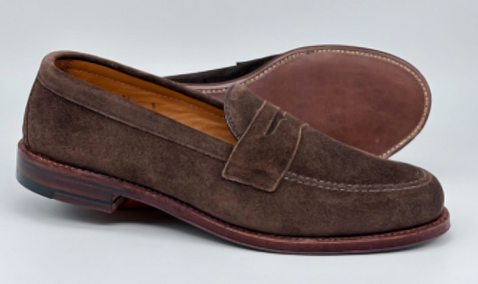 Alden Madison’s 6175F - Penny Loafer in Humus Suede, shown upright and on its side, highlights the Flex Oiled Leather Sole and fine stitching against a plain light background.