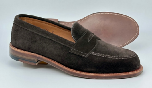 Alden Madison 6176F Penny Loafer in Dark Chocolate Suede—one shoe upright, the other on its side to show the light brown Flex Oiled Leather Sole.
