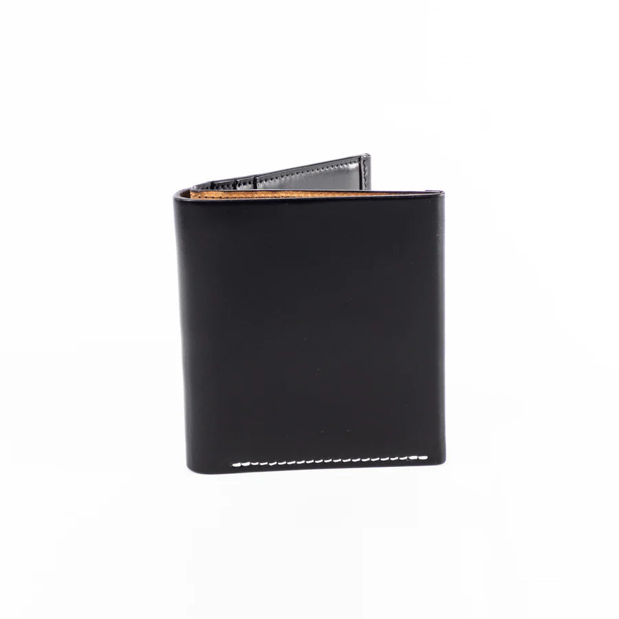 The Alden Madison LG 7009 - Alden Black Shell Cordovan Wallet stands upright against a white background, showcasing its minimalist black leather design with visible bottom stitching and discreet interior card slots.