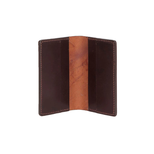 Viewed from above, the Alden Madison Credit Card Wallet in Shell Cordovan is an open brown leather wallet featuring a suede interior, four card slots, and a single-fold design.