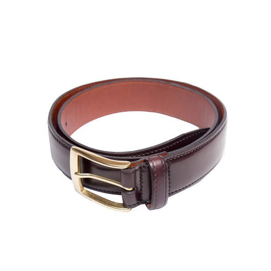 Alden Madisons A502 - Color 8 is a coiled 35mm brown leather belt with a shiny gold buckle, crafted from Horween Shell Cordovan. It features a smooth finish, visible edge stitching, and a lighter brown interior, showcasing its luxurious craftsmanship.