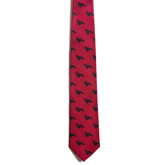 From Alden Madisons exclusive Kennel Club Collection, the Cocker Spaniel silk necktie features a red design with small black Texas silhouettes, making a bold fashion statement on a plain white background.